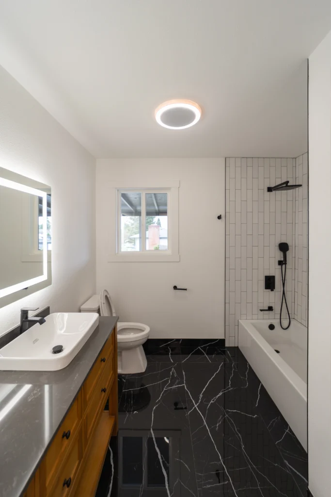 Newly Remodeled Bathroom With Modern Grey Countertops & Half Standing Sinks