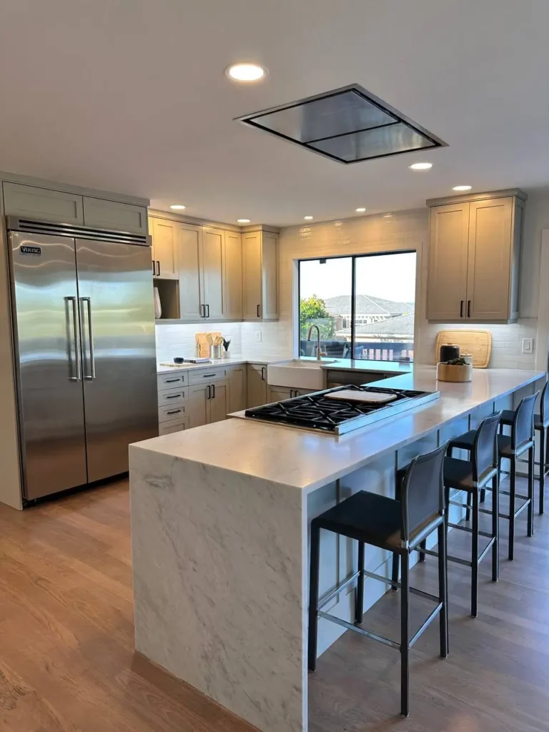 Modern Kitchen Remodel With White Overflow Countertops & Black Accents