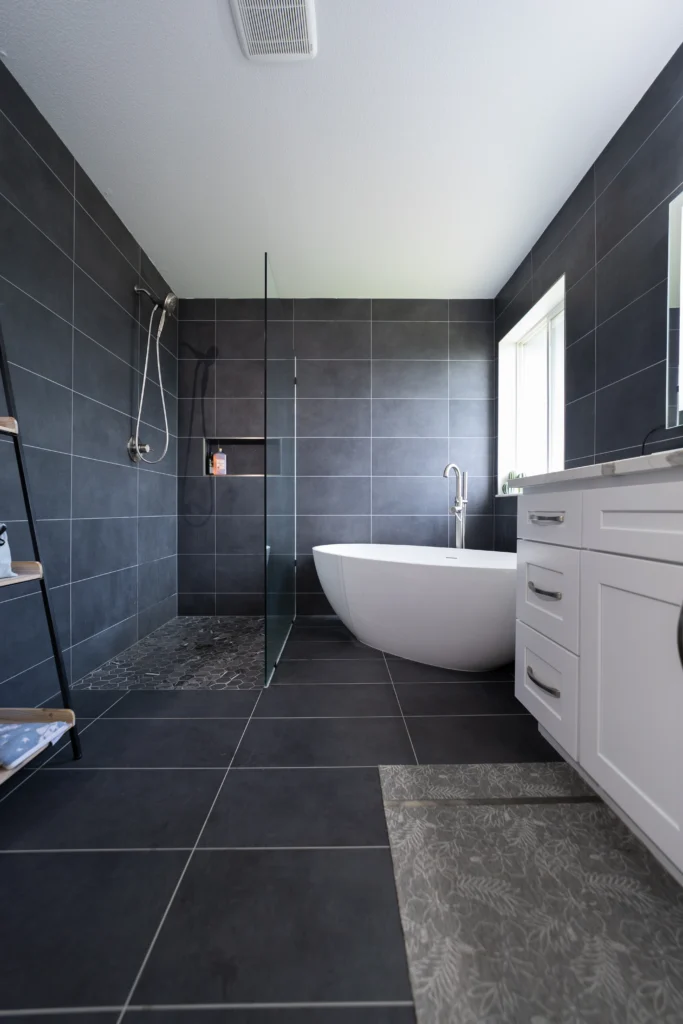 Modern Grey Tile Bathroom Remodel With Standing Tub & Glass Shower