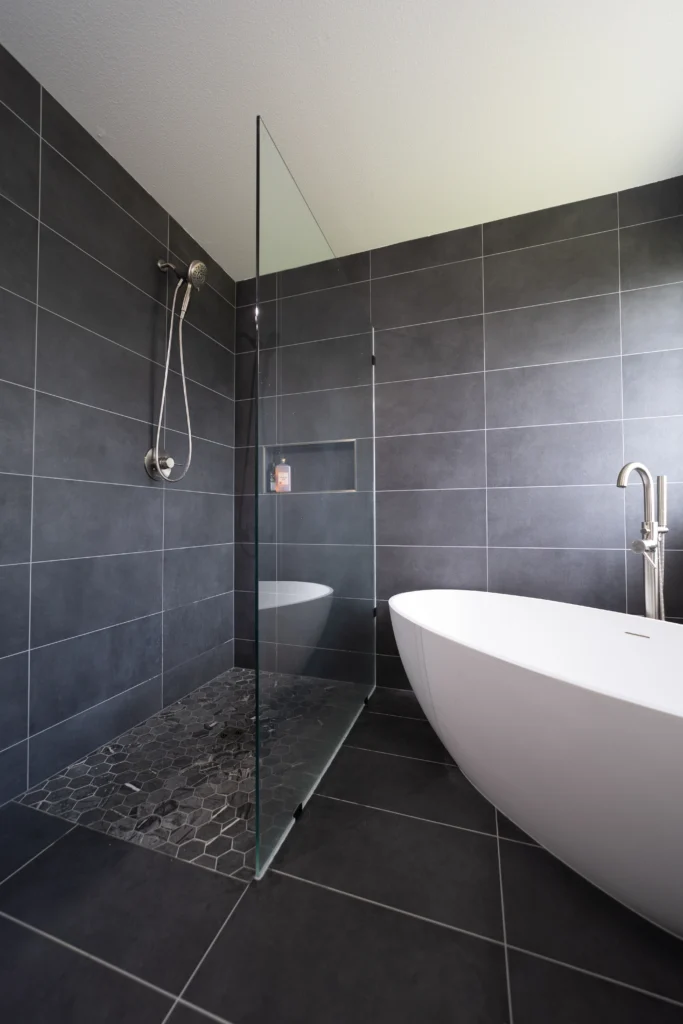 Large Grey Tile Bathroom Remodel With Standing White Tub