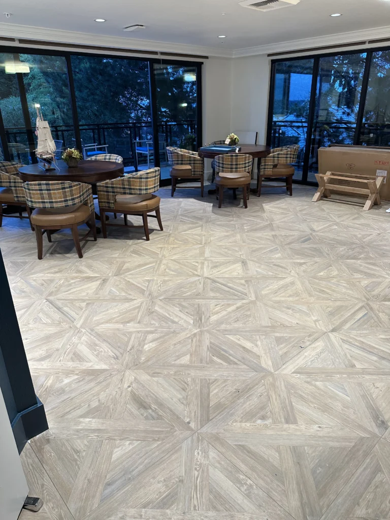 Communal Living Area With Dimond Pattern Hardwood Flooring