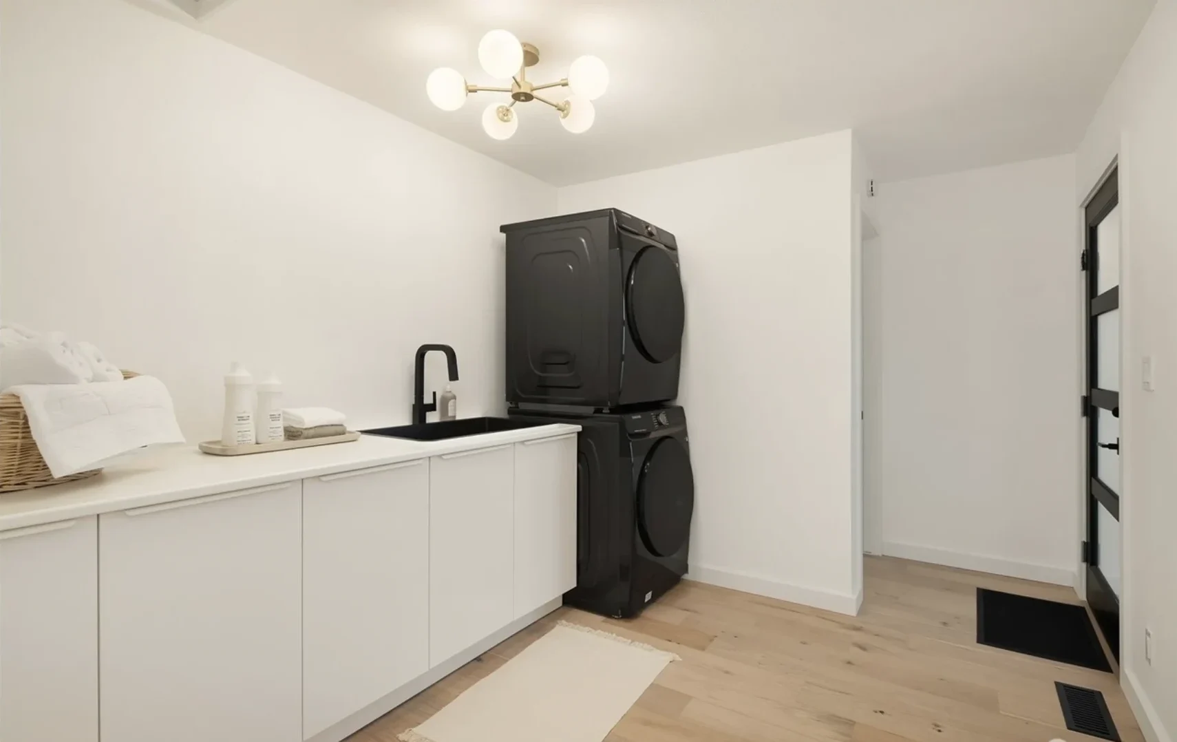 Modern White Laundry Room With Double Stacked Washer and Dryer Combo