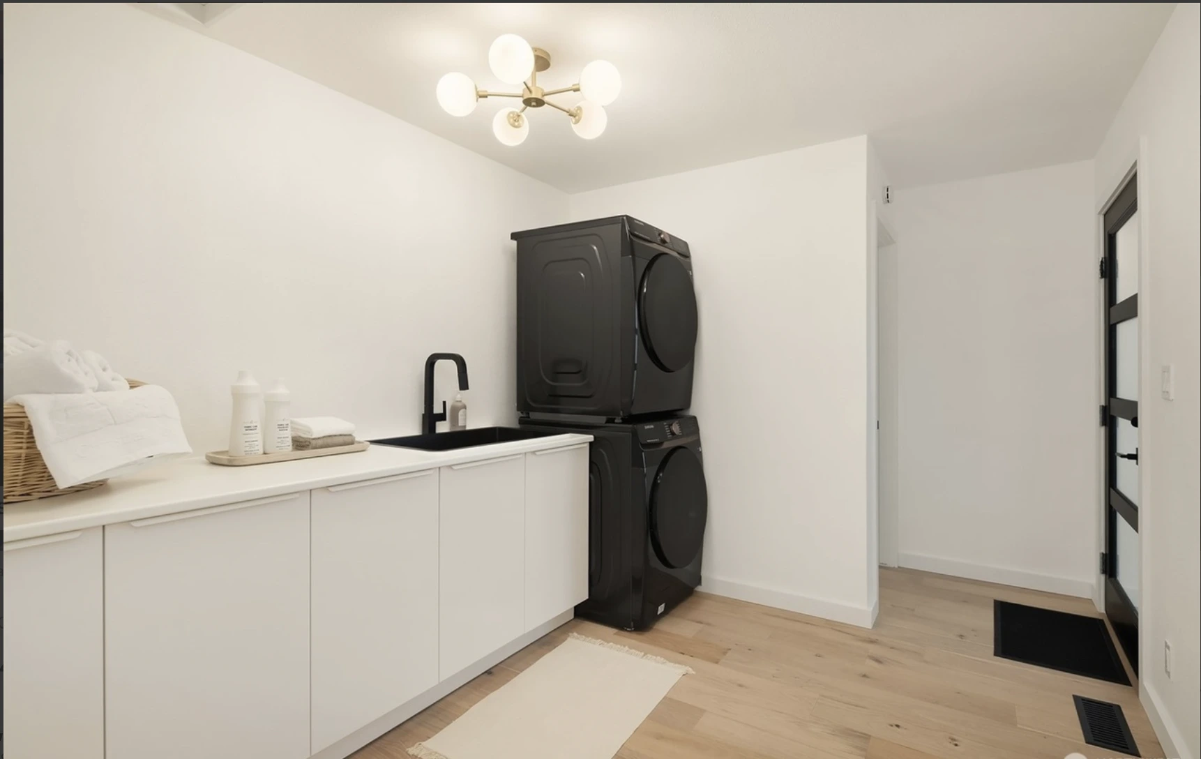 Modern White Laundry Room With Double Stacked Washer and Dryer Combo