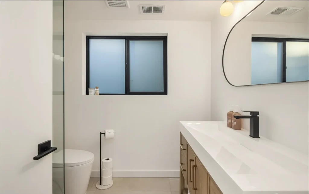 White & Brown Bathroom Remodel With Thick Slab Sink With 1 Faucet but full countertop capability
