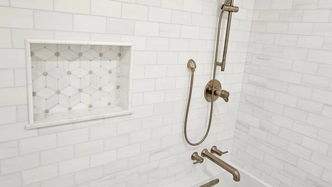 Newly Tiled & Remodeled White Bathroom With Bronze Fixtures